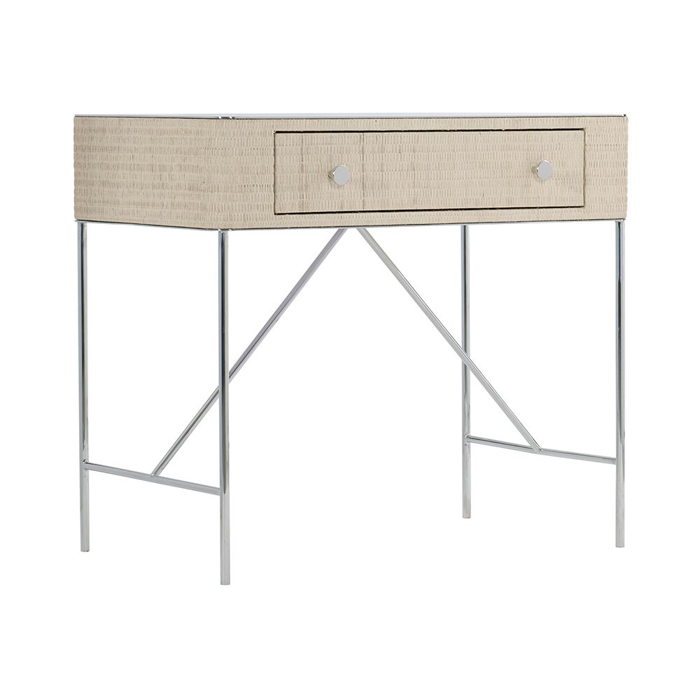 A chic and contemporary bedside table featuring a woven bleached raffia wrapped drawer box and finished with a polished stainless steel top and base