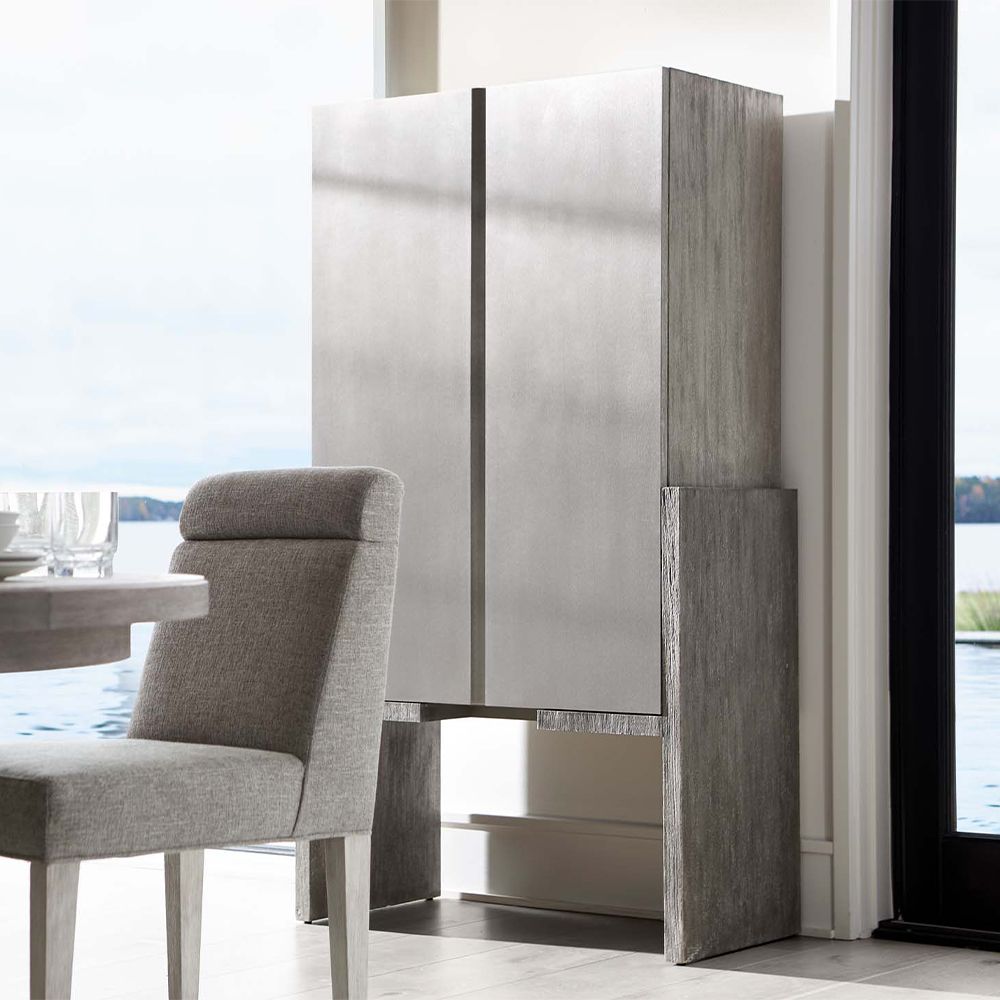 A stylish two door bar cabinet featuring a lovely two tone finish, a mirrored glass back panel and plenty of storage for all of your bar essentials