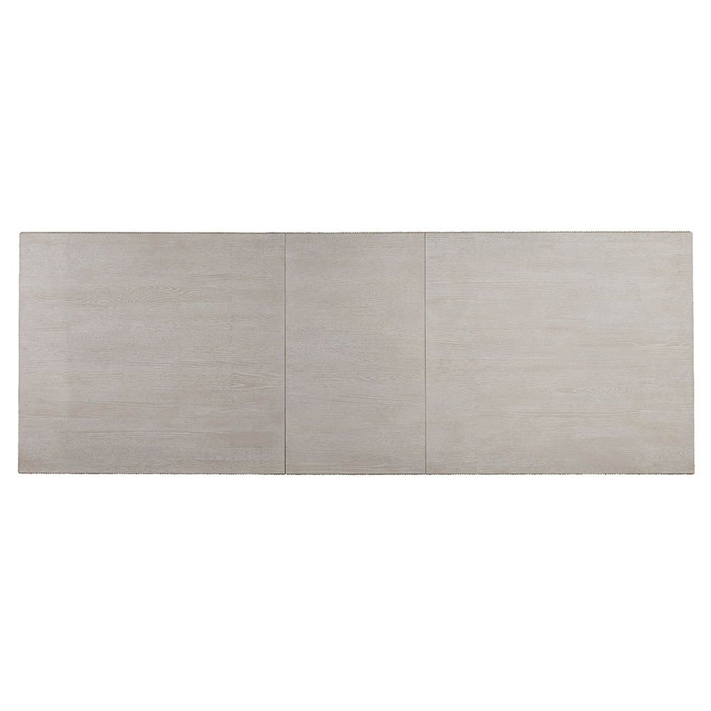 Rectangular dining table with matte-finished wood and bronze base