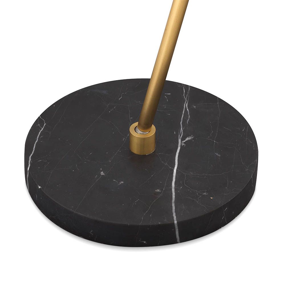 Elegant and unique floor lamp with orb shades and brass stem mounted on black marble base