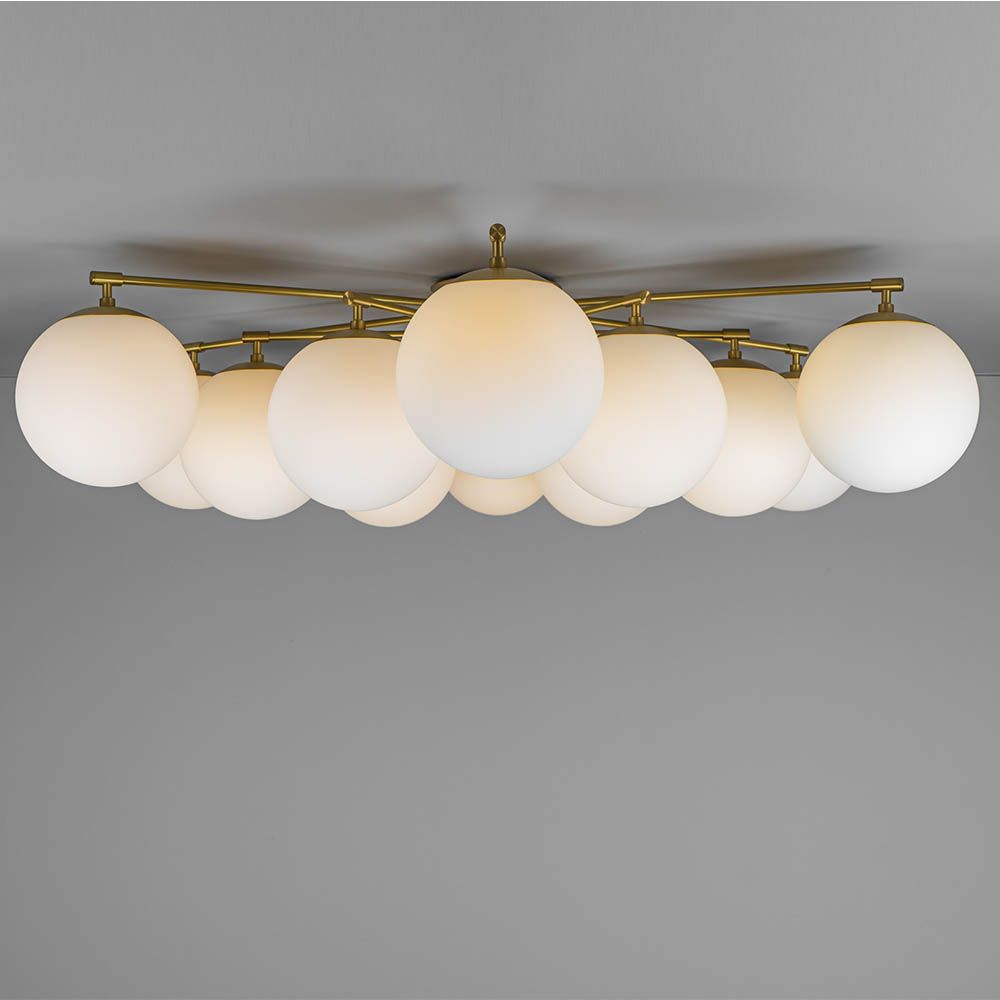 Elegant ceiling light with round white shades and brass fixture