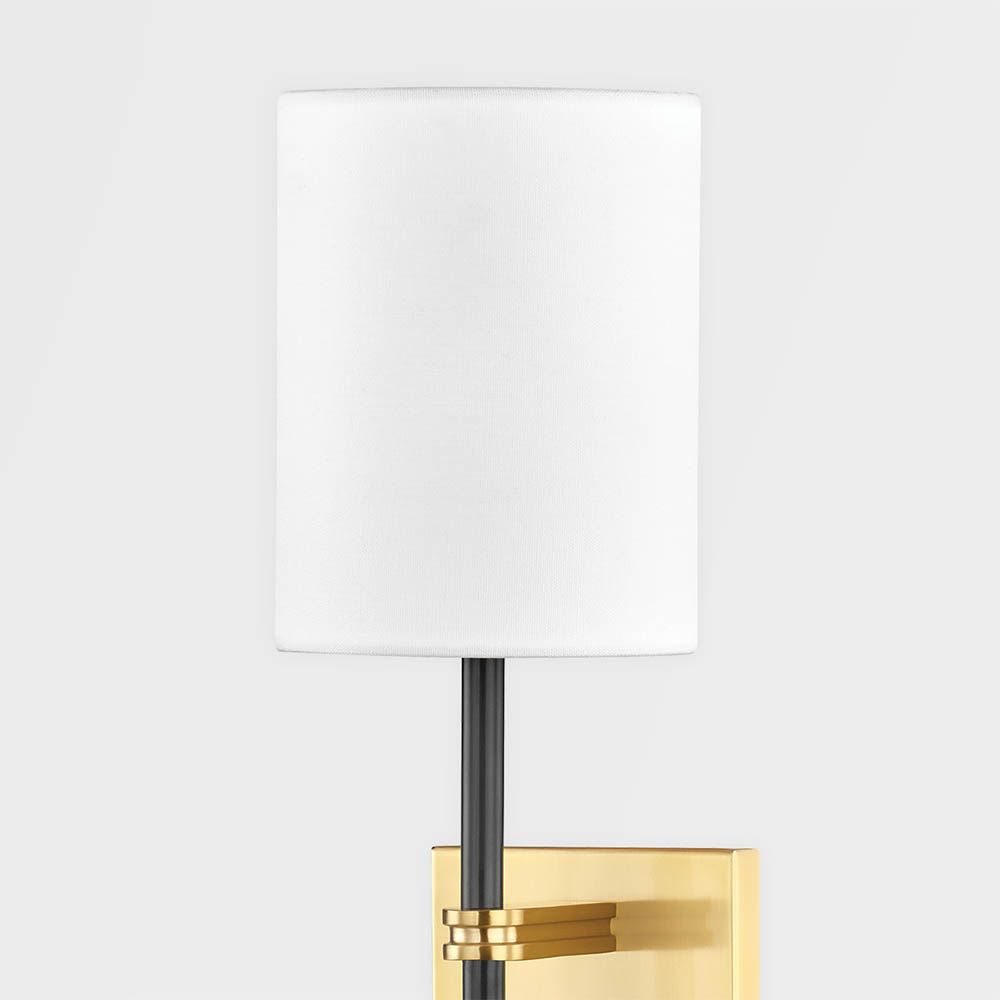 Modern wall sconce with brass fixture for added glamour