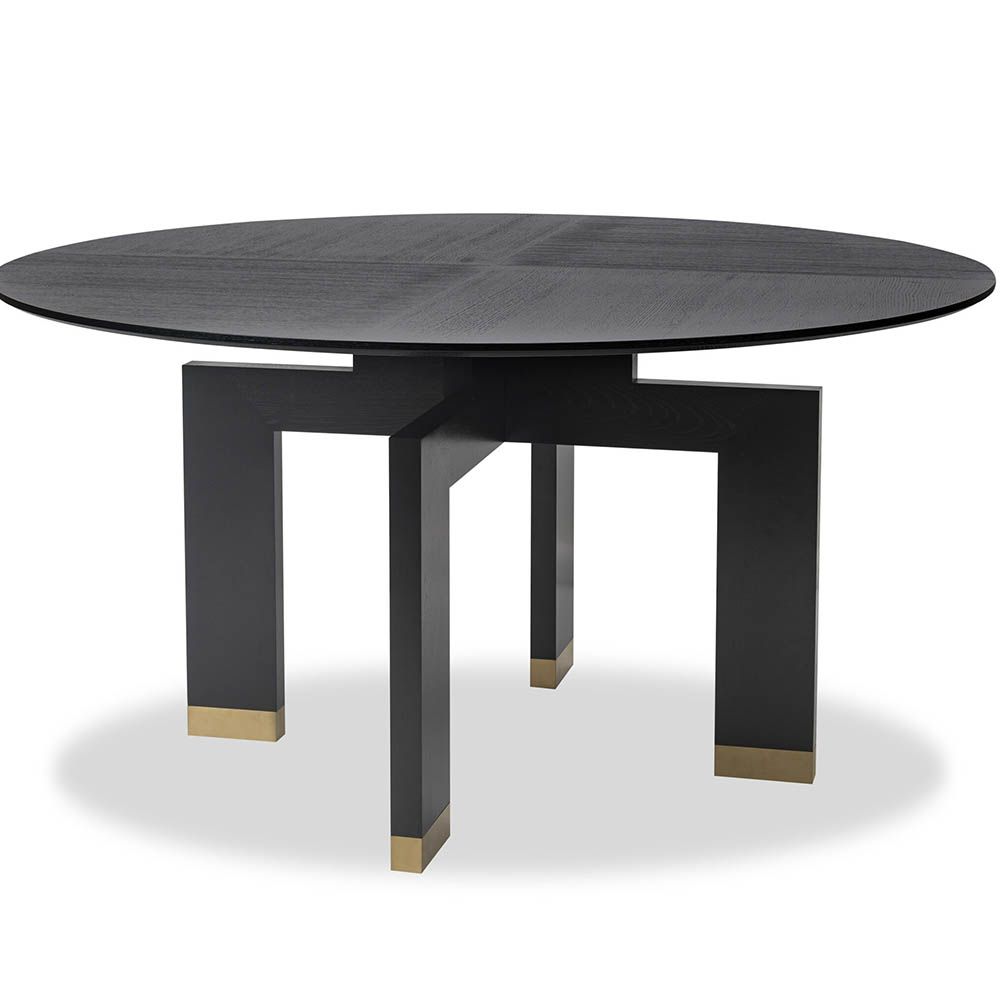 Smooth circular top dining table elevated by a sturdy geometric support