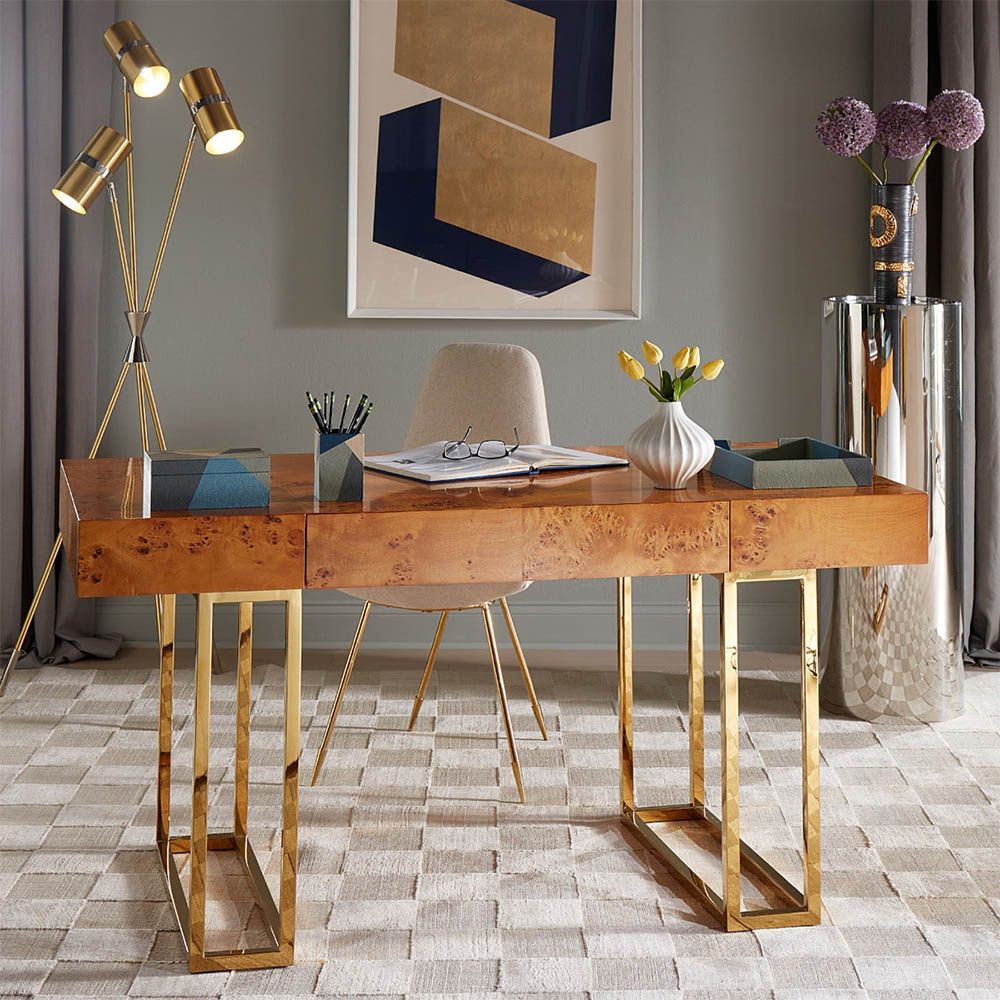A classic burled mappa desk with a polished brass base
