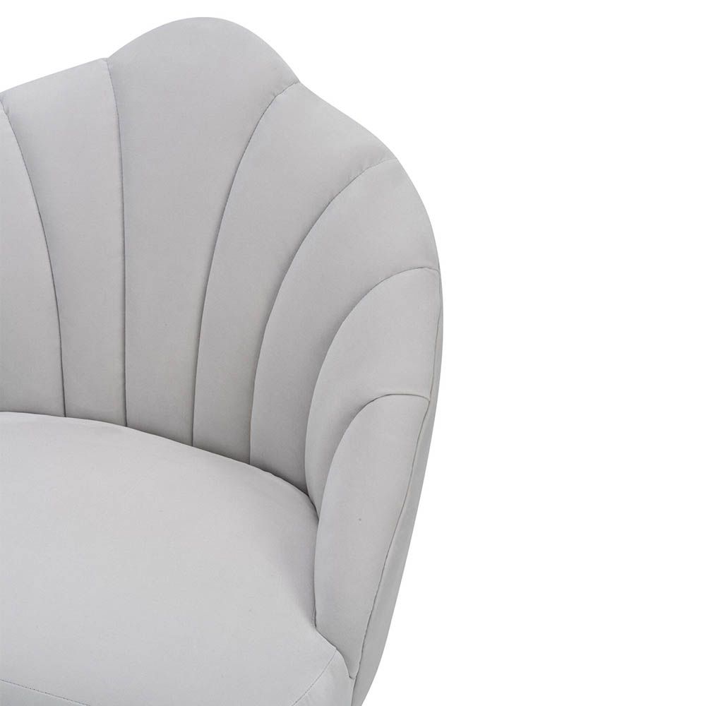 Light grey velvet chair with statement leaf backrest and tapered brass legs
