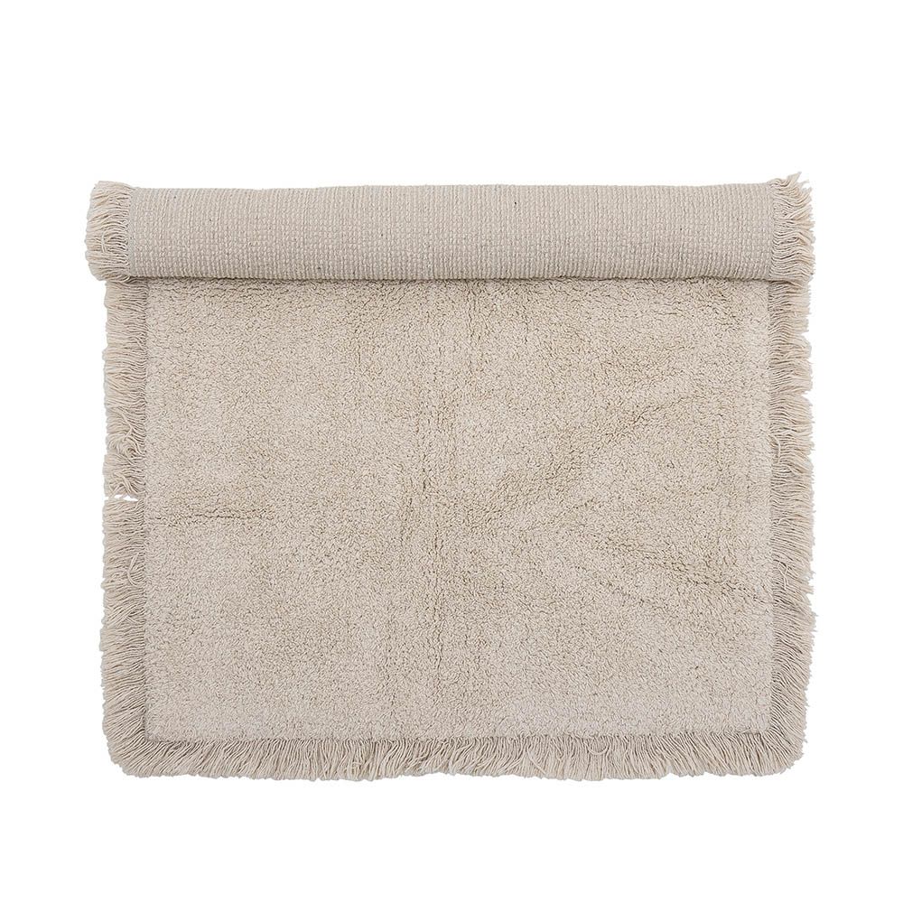 Natural wool rug with fringe detail