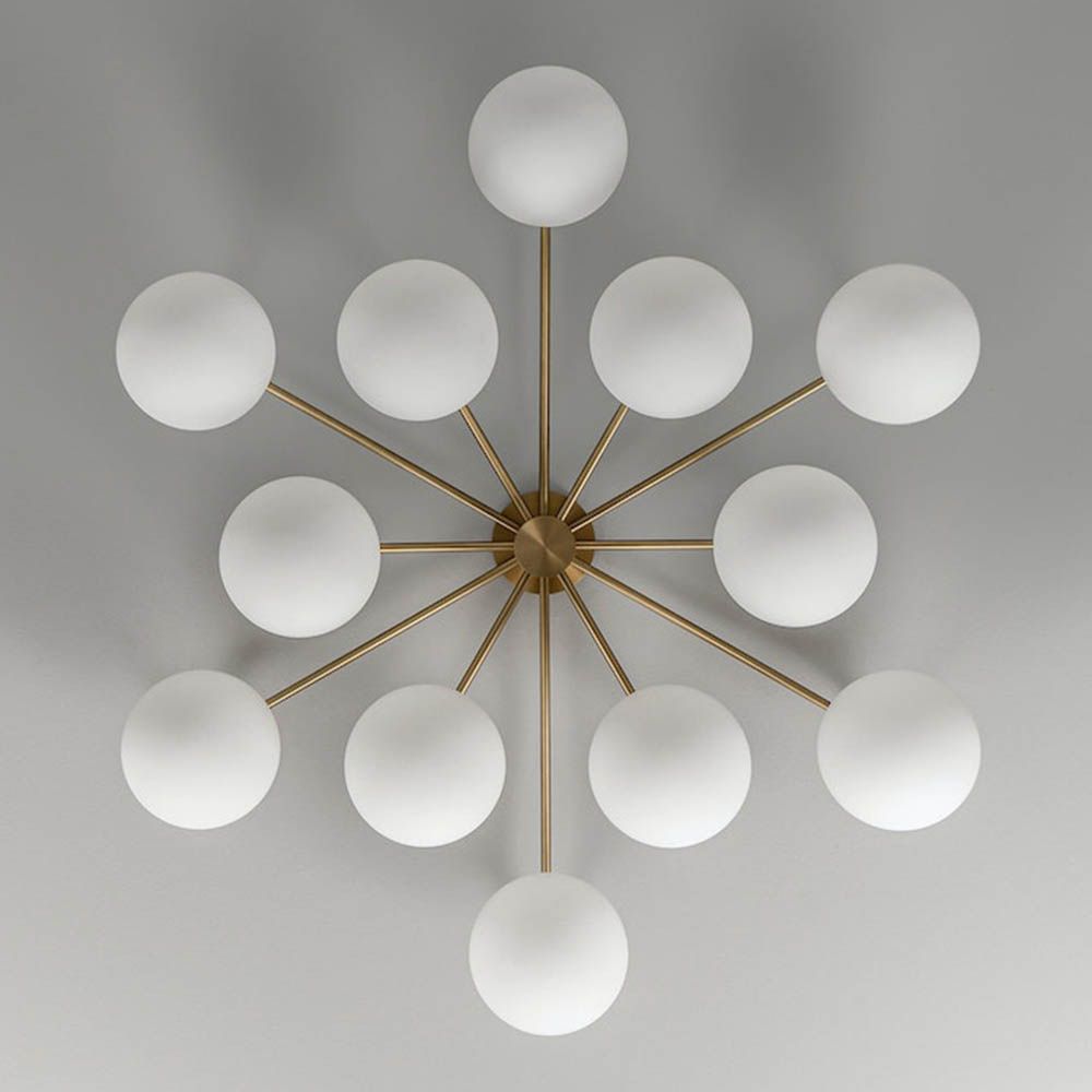Elegant ceiling light with round white shades and brass fixture