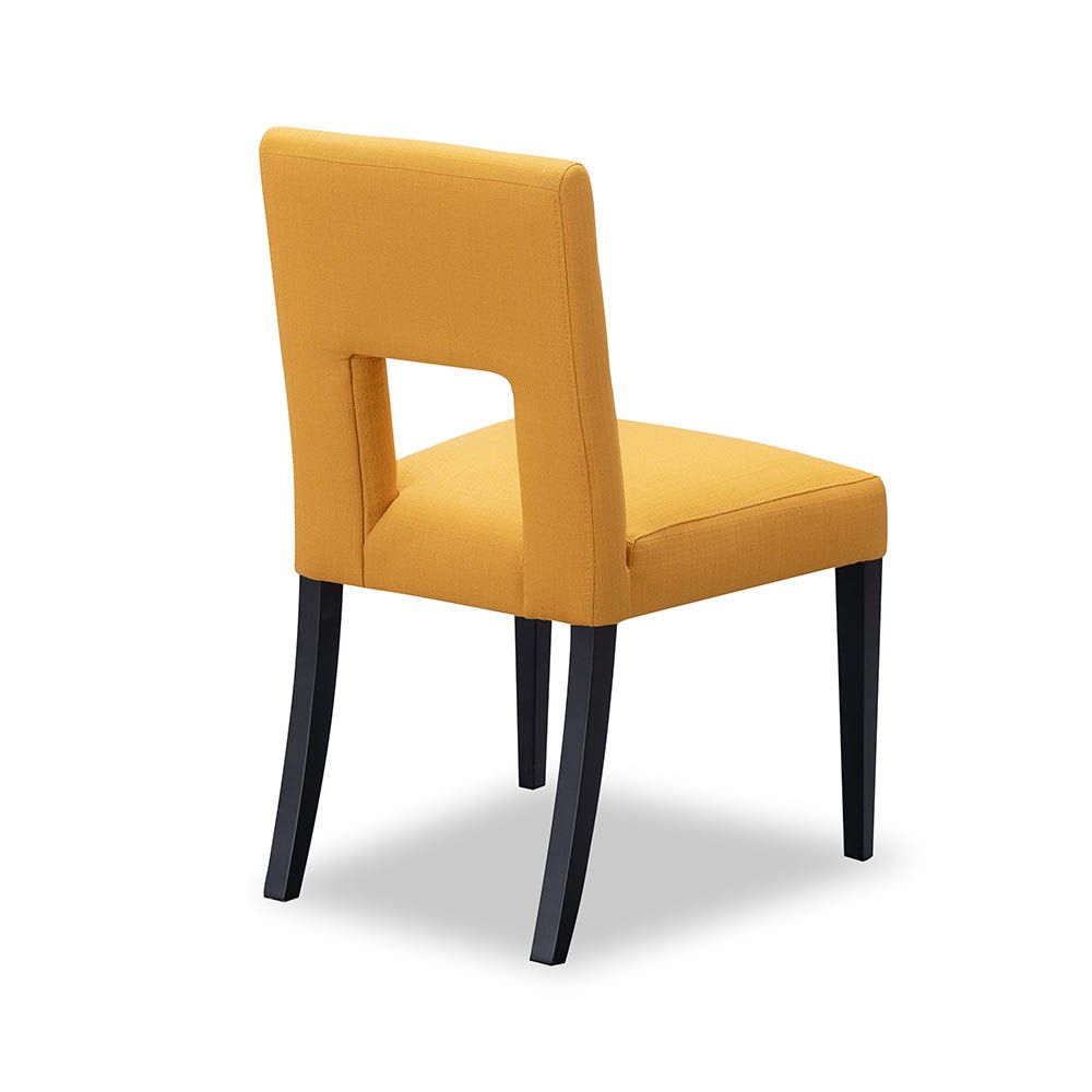Dining chair with square cut out shape in backrest and luxurious mustard linen upholstery