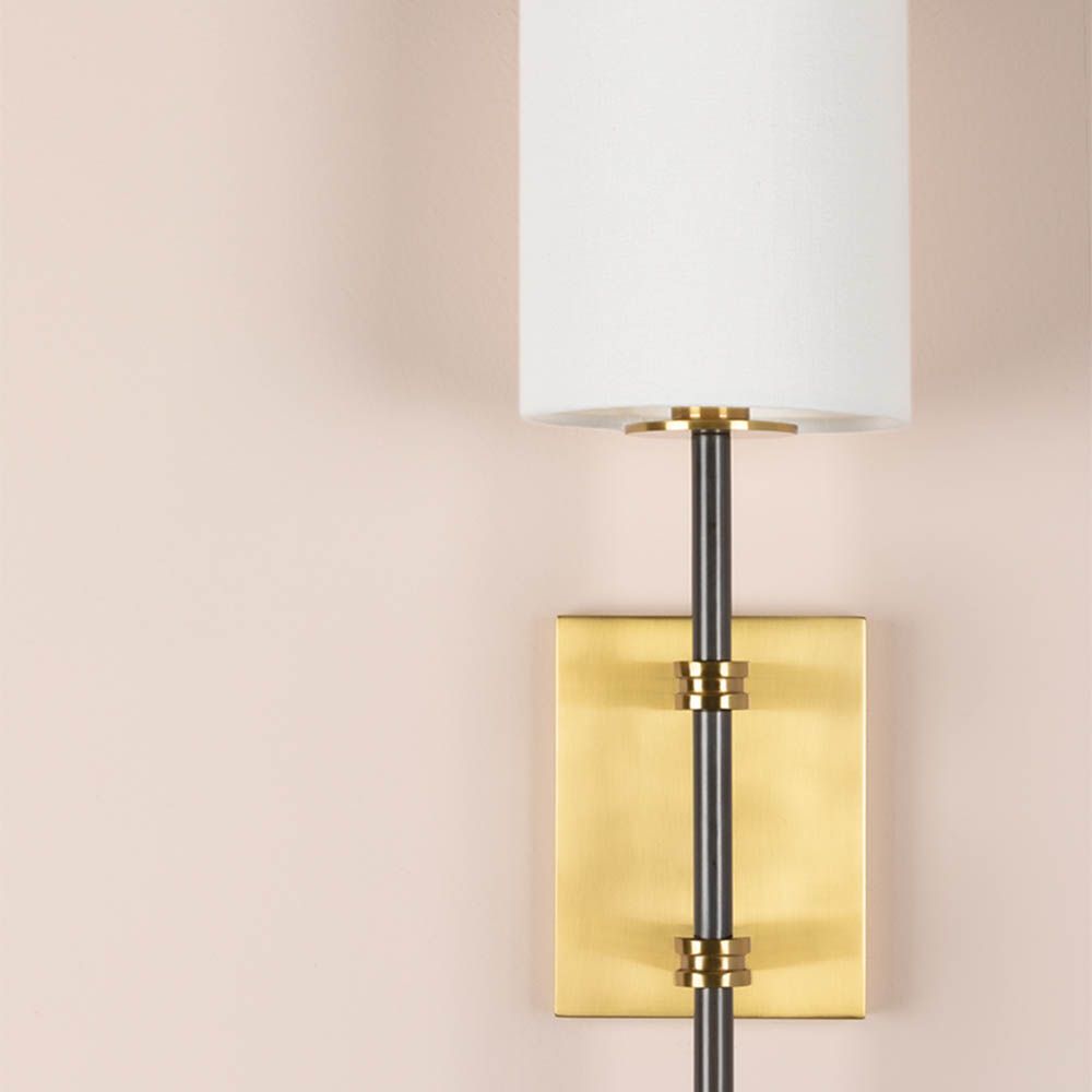 Modern wall sconce with brass fixture for added glamour