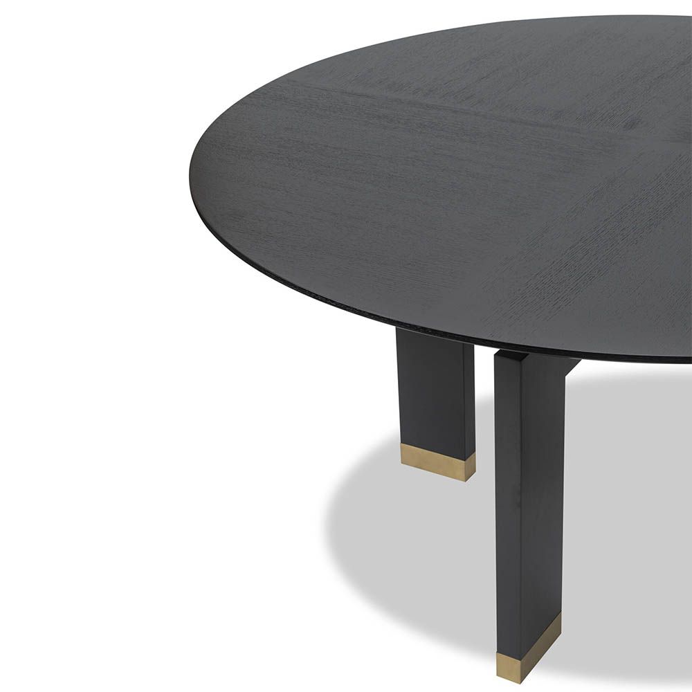 Smooth circular top dining table elevated by a sturdy geometric support