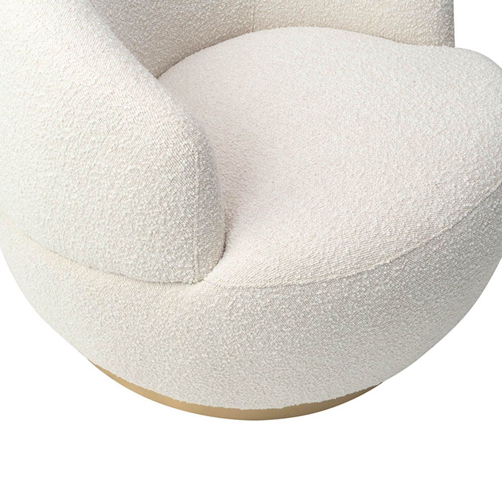 Small and circular boucle sand swivel chair with rounded edges and brass base