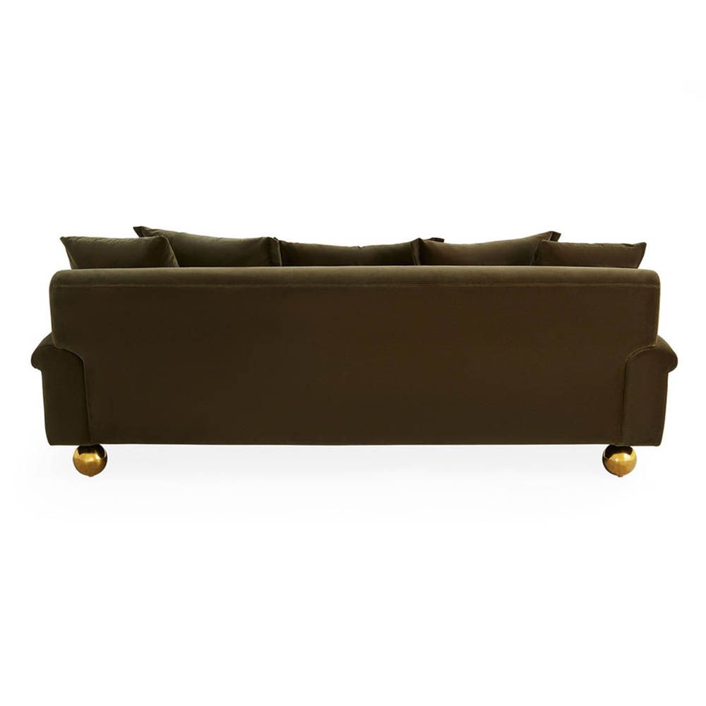 Olive green sofa with oversized brass orb feet