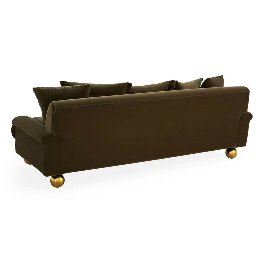Olive green sofa with oversized brass orb feet