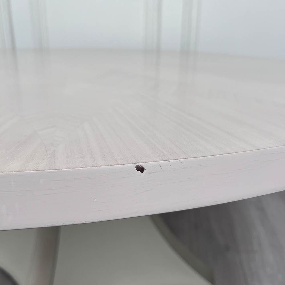 Round and decorative dining table with sculptural base