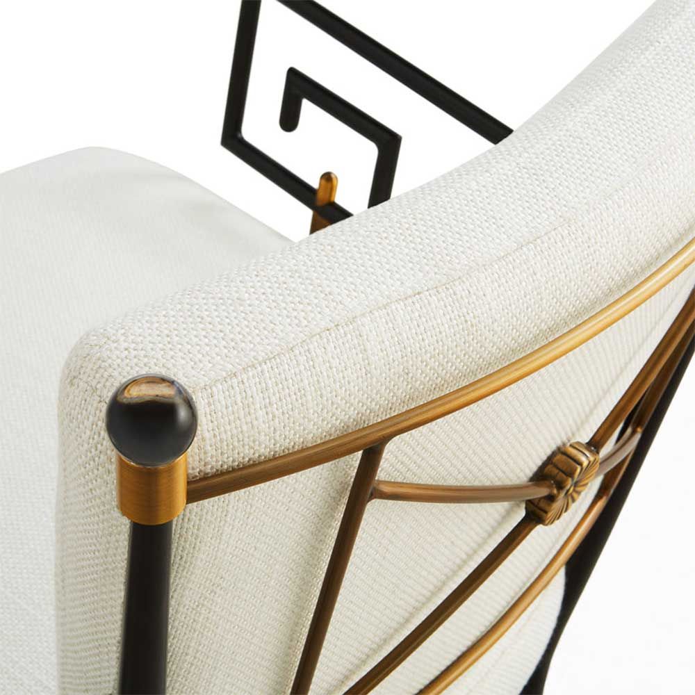 Black framed armchair with brass accents and linen seat and back cushions