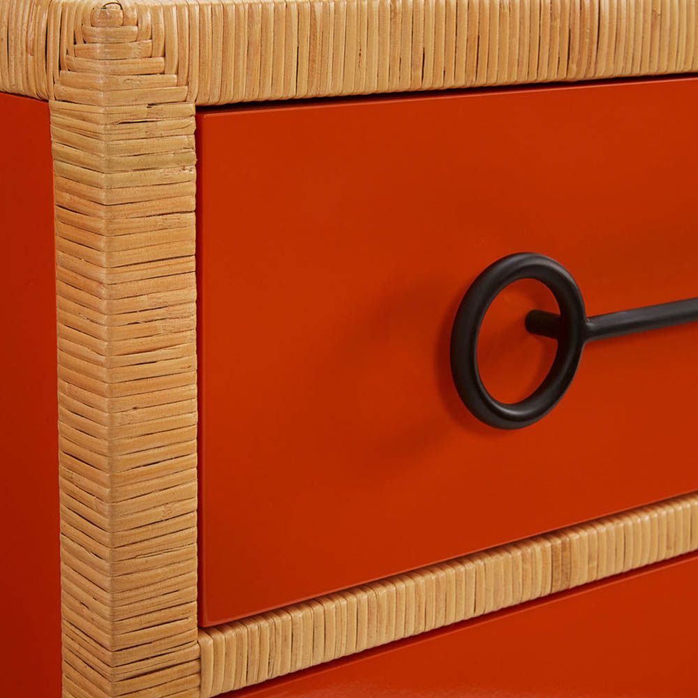 Red and orange chest of three drawers with rattan edges
