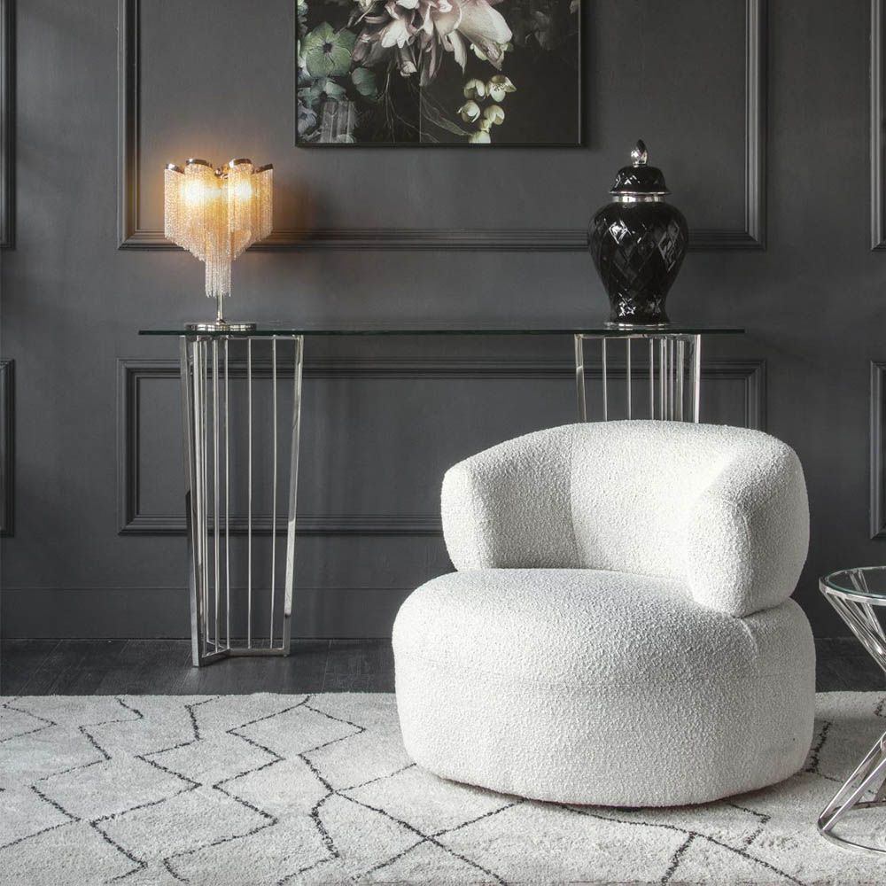 Stainless steel console table with geometric legs and clear glass top