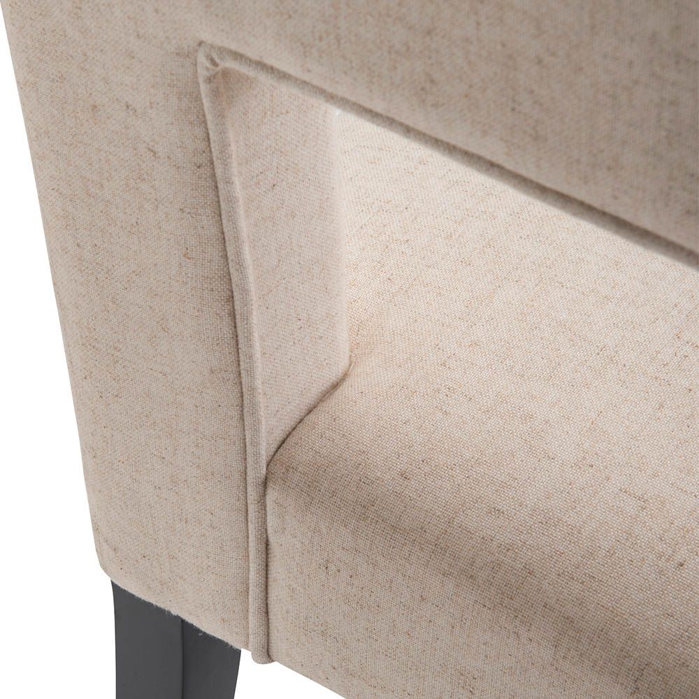 Beige dining chair with square cut out shape in backrest and luxurious linen upholstery