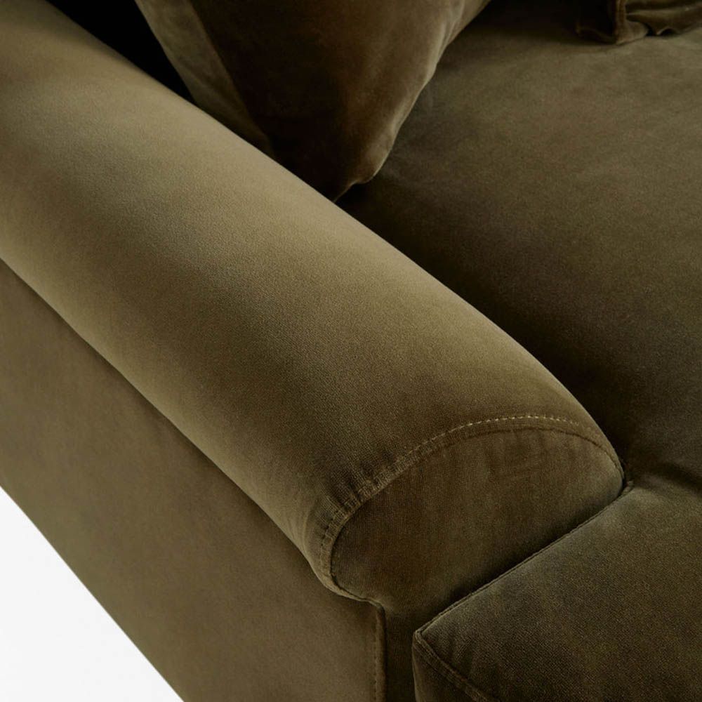Olive green sofa with oversized brass orb feet