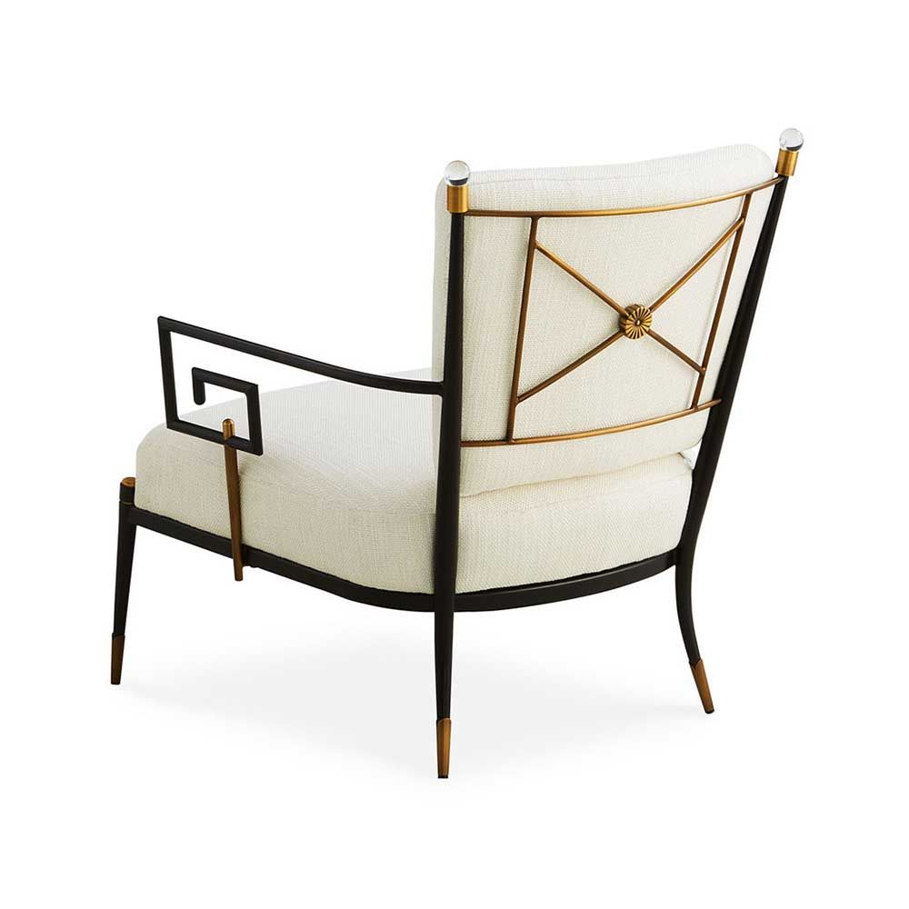 Black framed armchair with brass accents and linen seat and back cushions