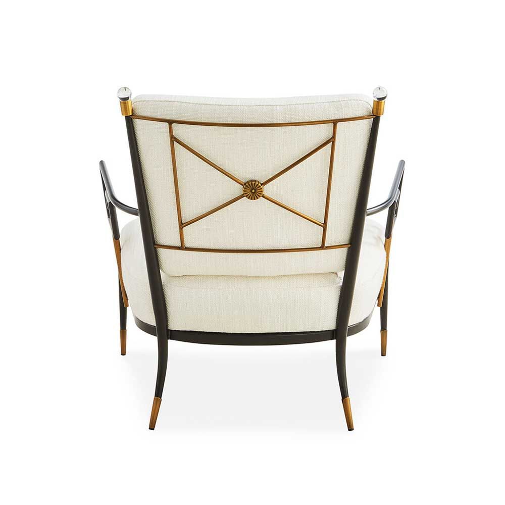 Black framed armchair with brass accents and linen seat and back cushions