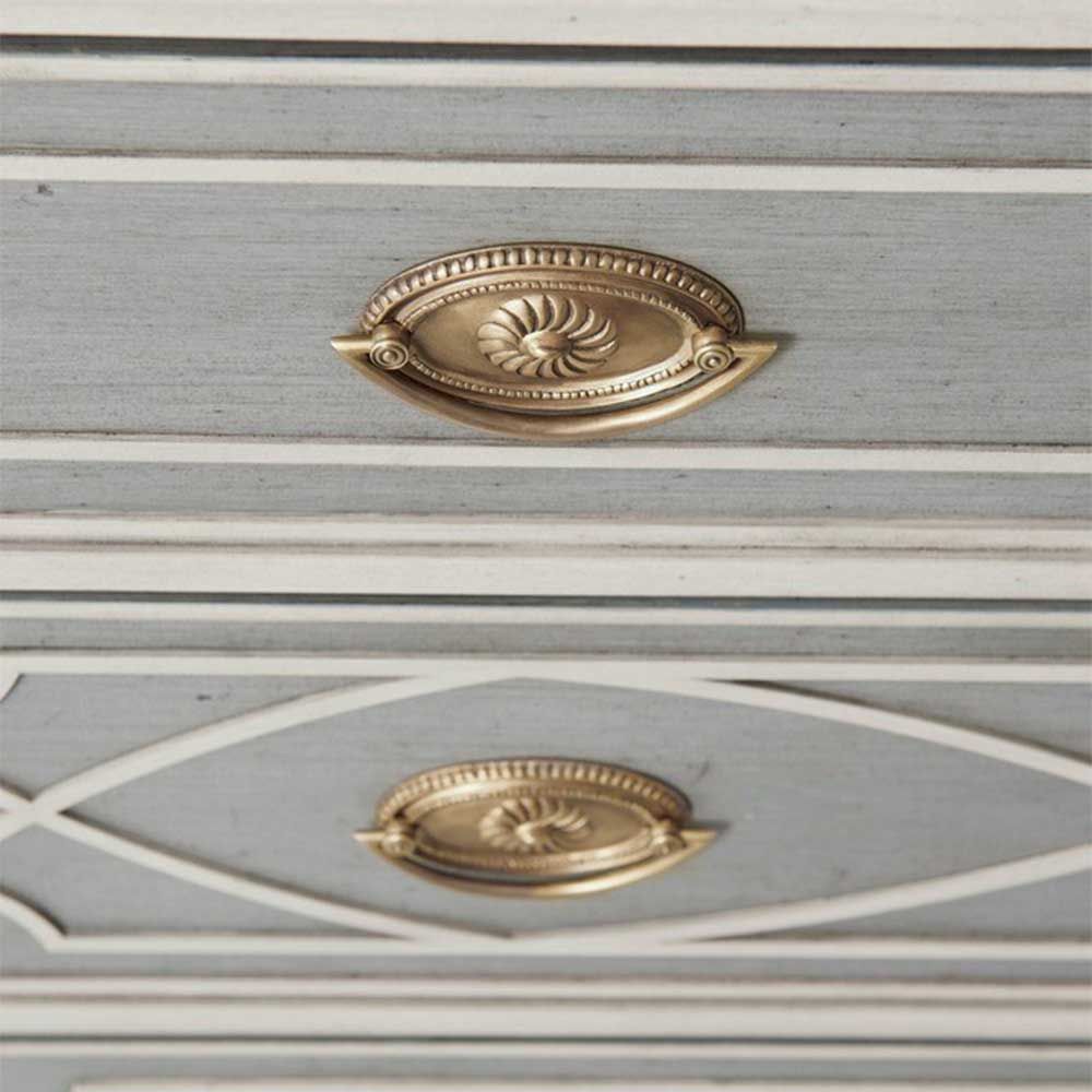 Grey chest of drawers with cream art-deco patterning and intricate brass handles