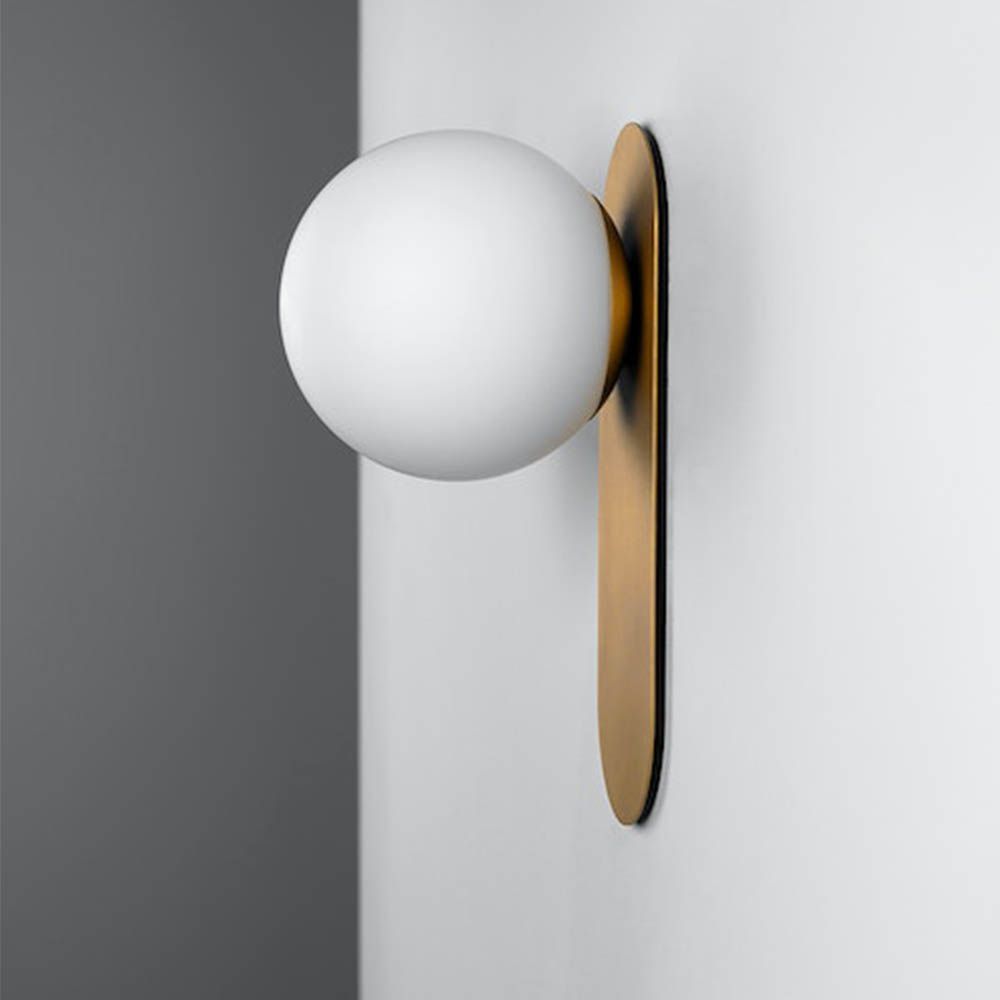 wall sconce with beautiful brushed brass finish and an elegantly detailed frosted glass bulb
