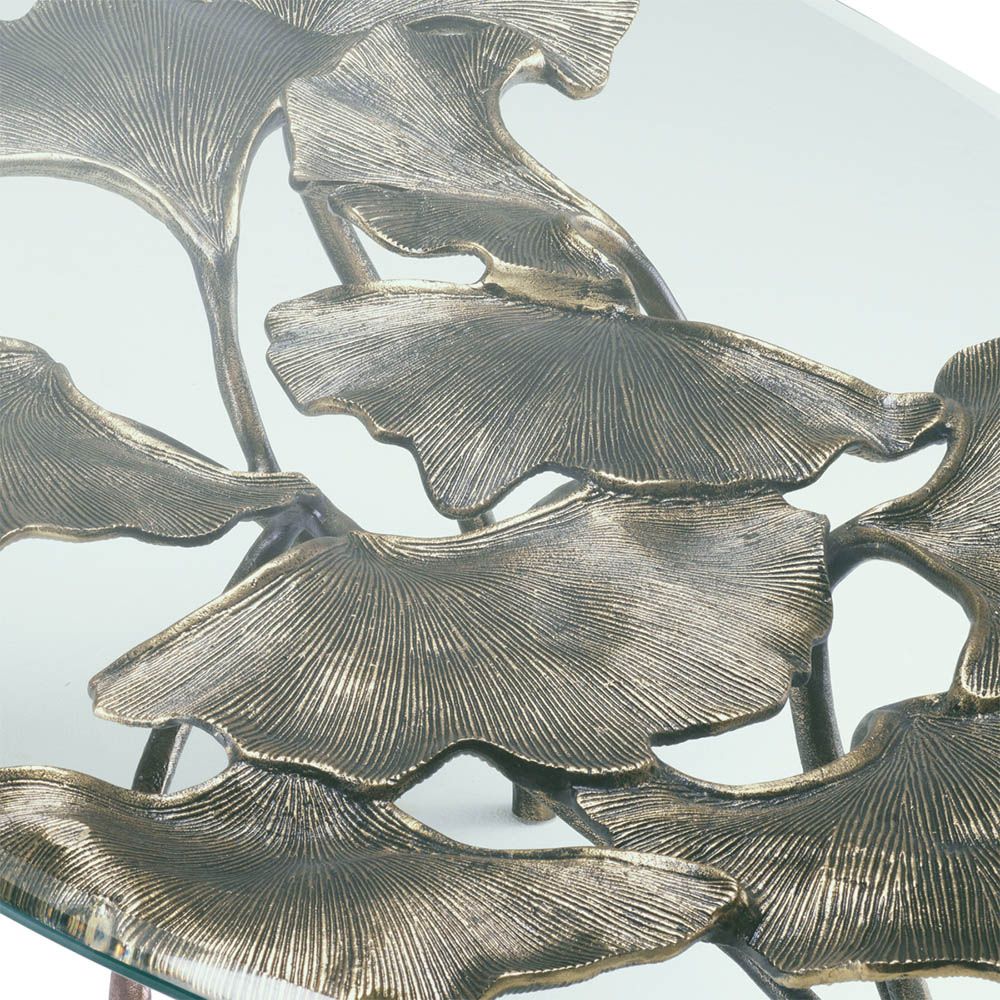 Opulent coffee table with leaf design brass base and round glass top