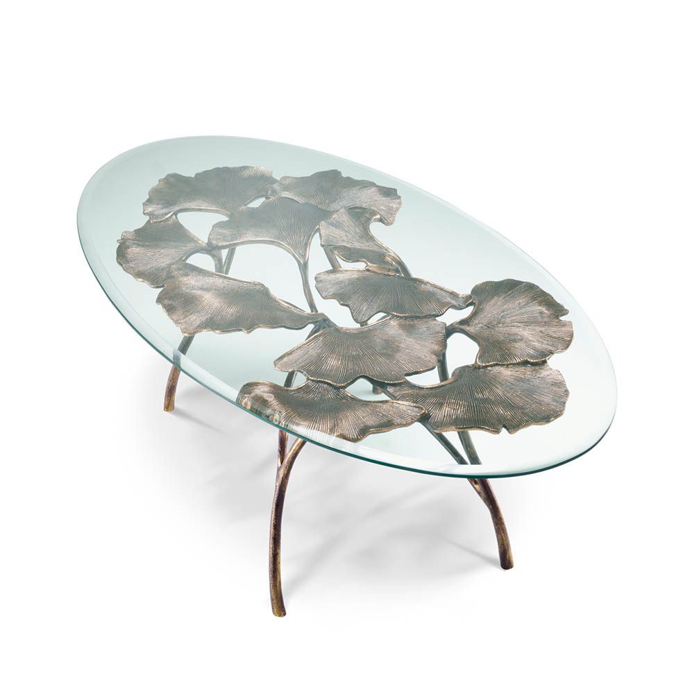 Opulent coffee table with leaf design brass base and round glass top