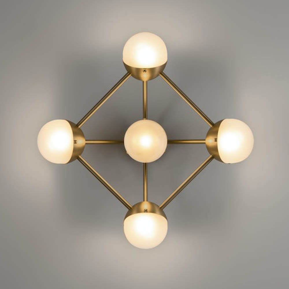Elegant brass wall fixture with five frosted orb shades and geometric appeal