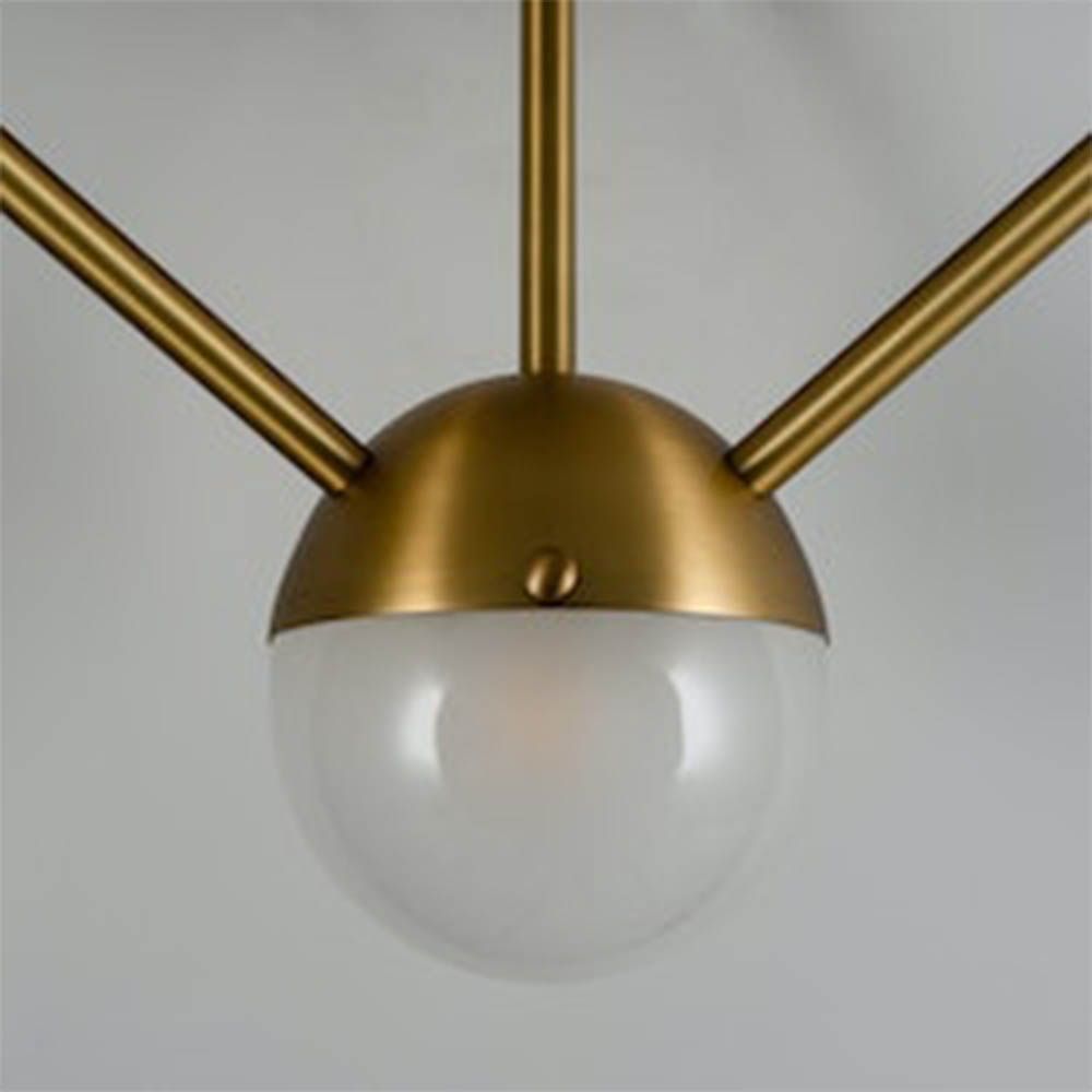 Elegant brass wall fixture with five frosted orb shades and geometric appeal