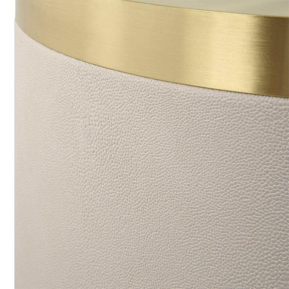 Luxurious round ivory accent table with brass top