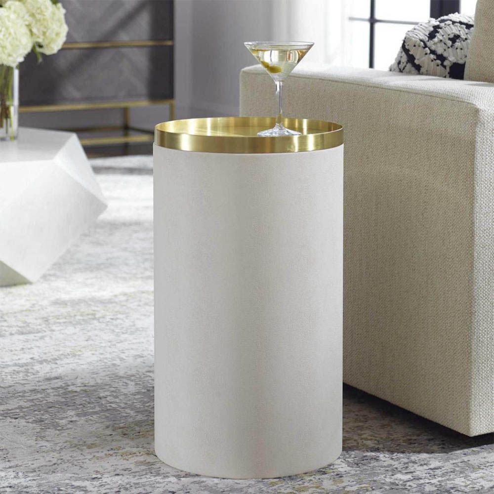 Luxurious round ivory accent table with brass top