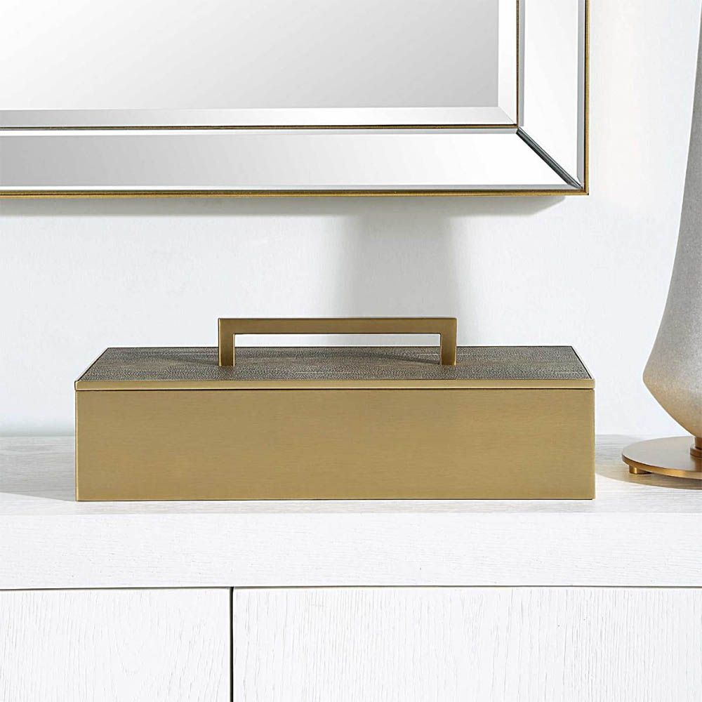 A glamorous brass box by Uttermost with a grey faux shagreen finish 
