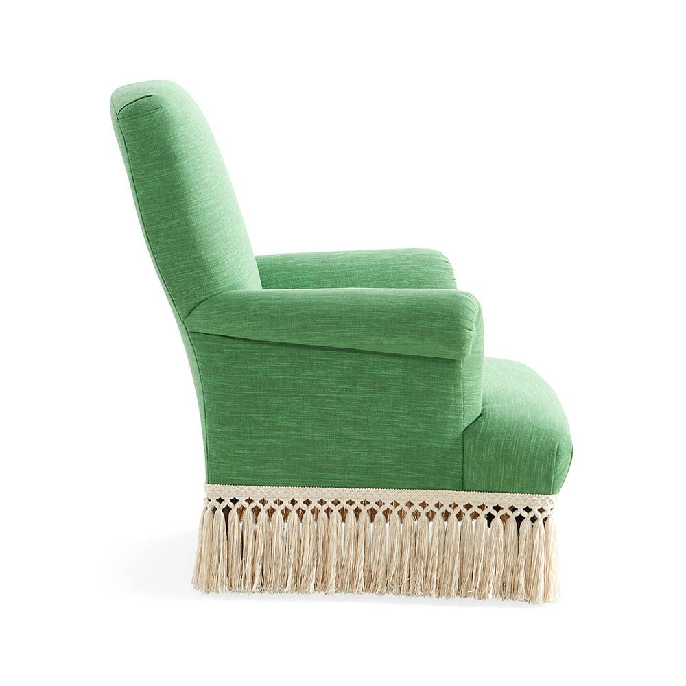 Green armchair with cream fringe bottom