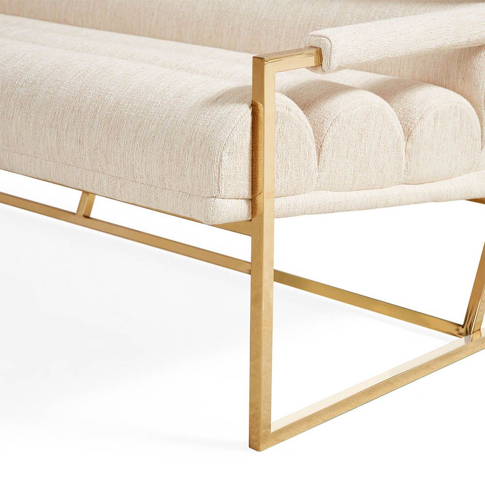 Upholstered beige sofa with brass detail