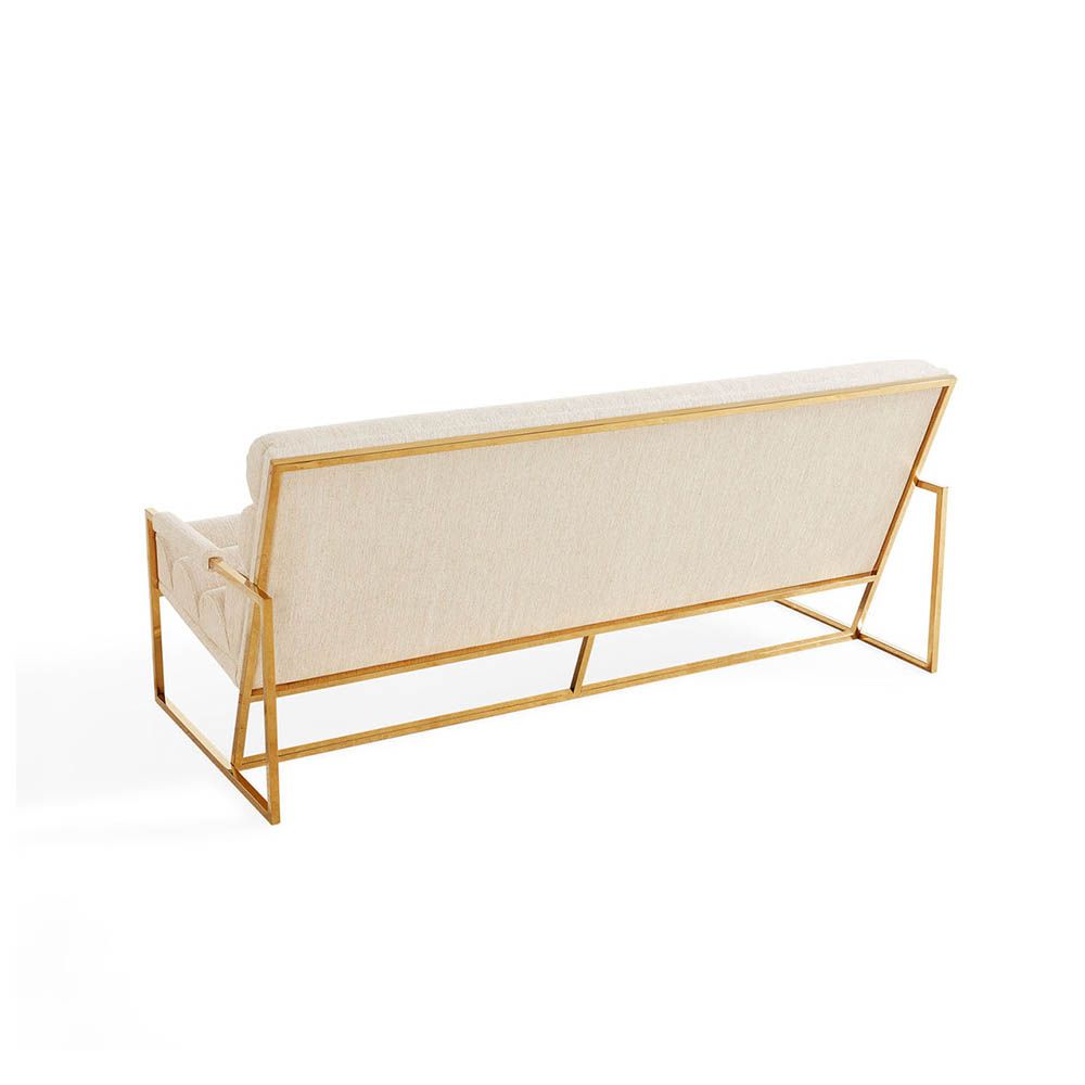 Upholstered beige sofa with brass detail