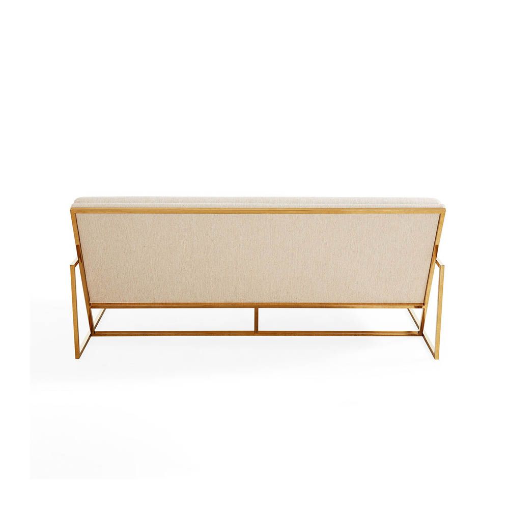 Upholstered beige sofa with brass detail