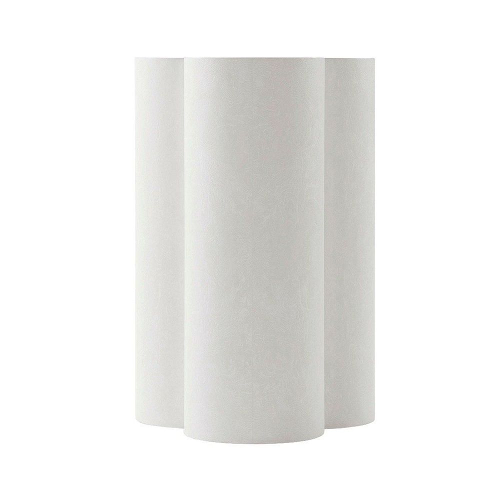 A contemporary side table with a trefoil design and white chalk finish 