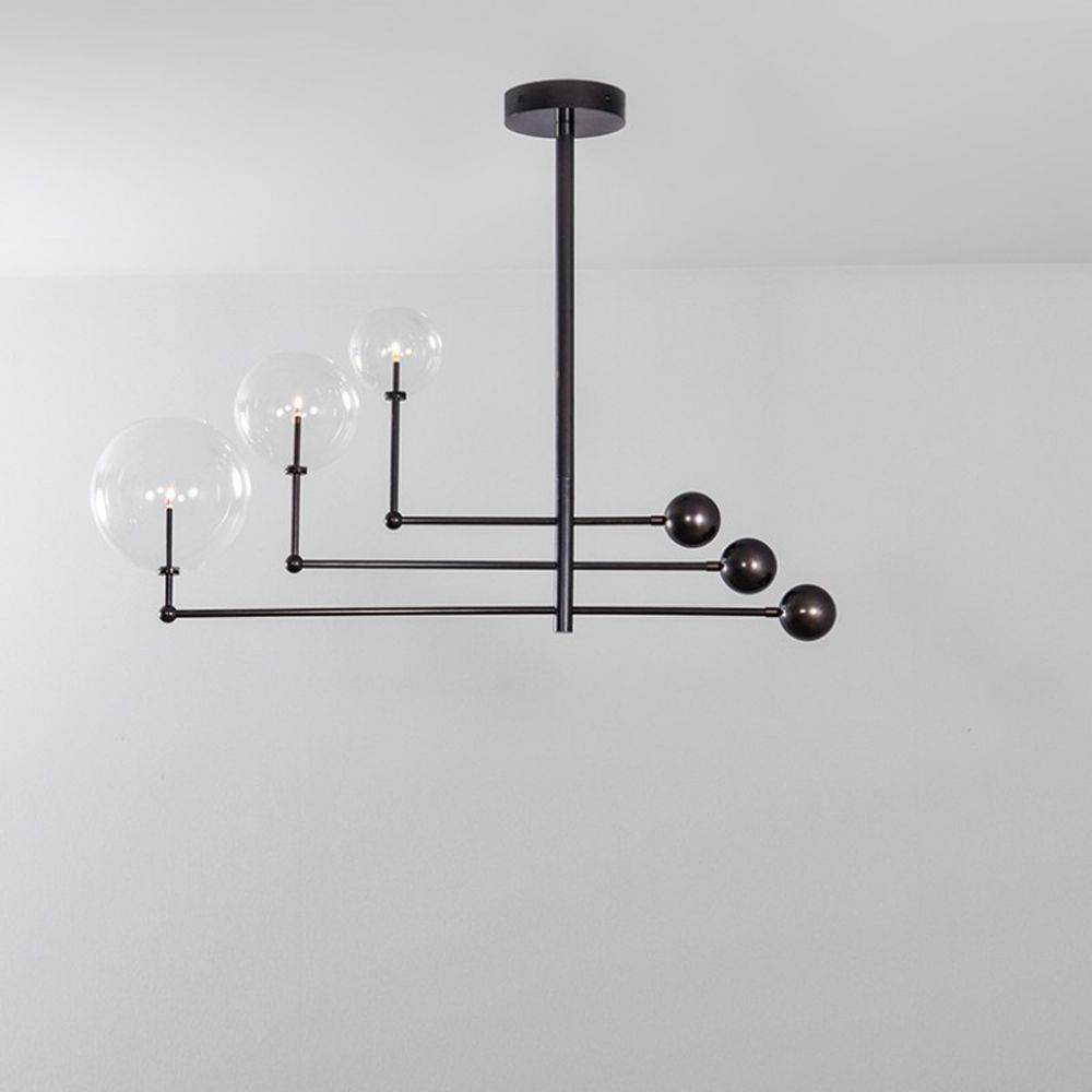 Black gunmetal finish chandelier with rotational arm fixture and clear glass globe design
