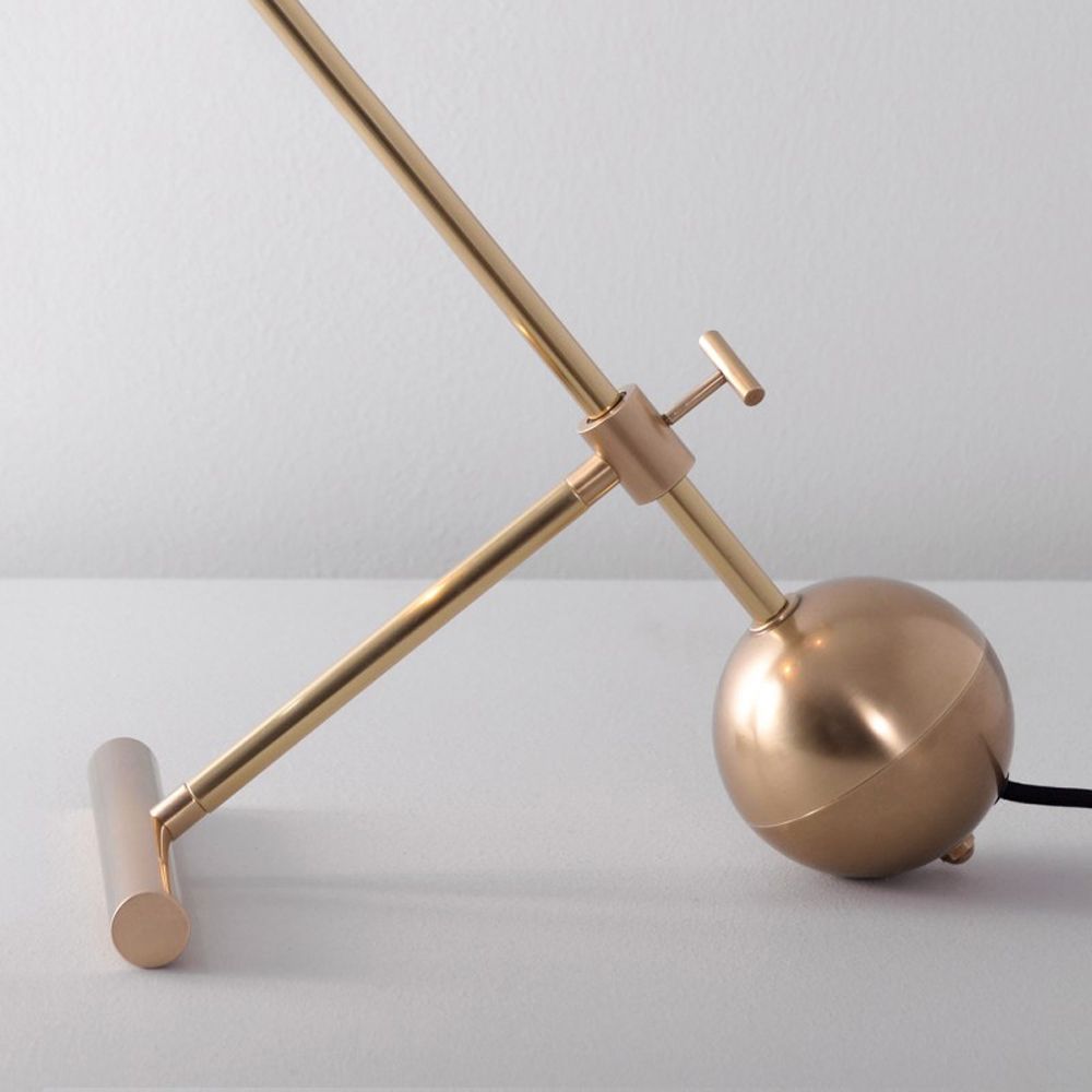 Industrial style table lamp in a natural brass finish with clear glass lampshade design