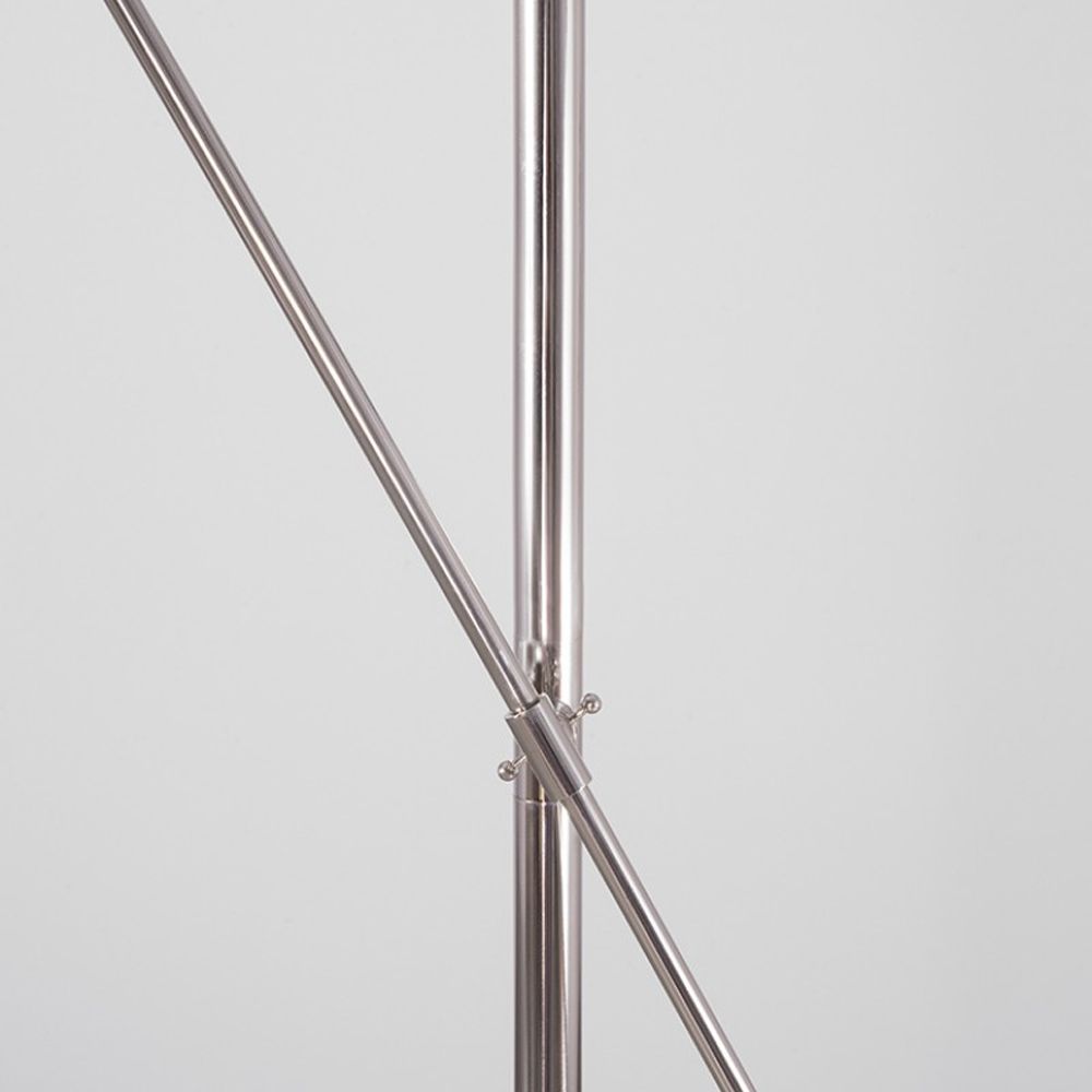 Polished nickel industrial floor lamp with angled frame and clear glass globe lampshade