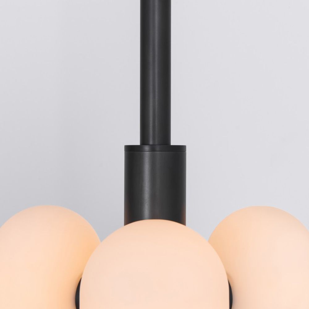 Contemporary retro style pendant ceiling light in a black gunmetal brass finish with translucent glass lampshade design