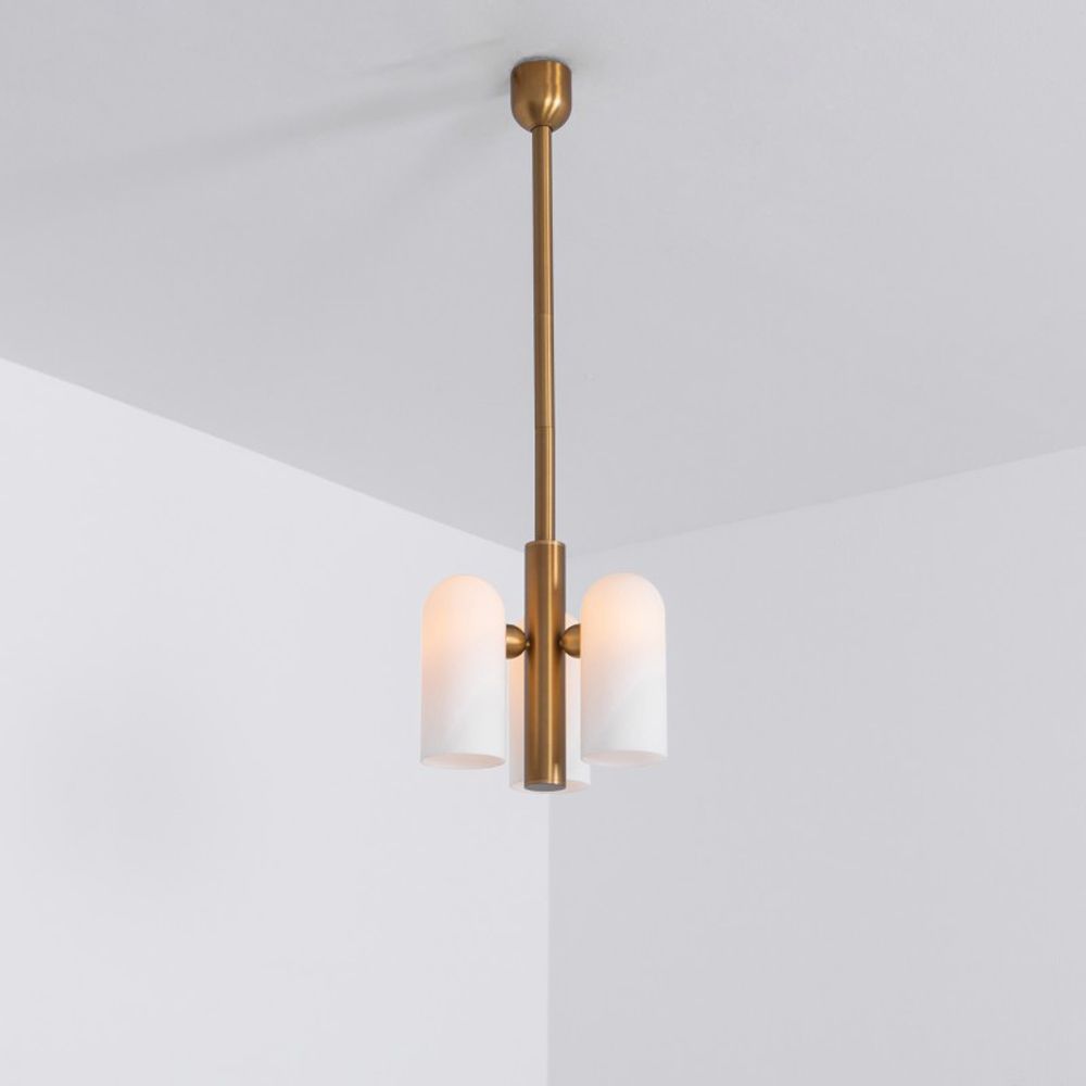 Contemporary retro style pendant ceiling light in a natural brass finish with translucent glass lampshade design