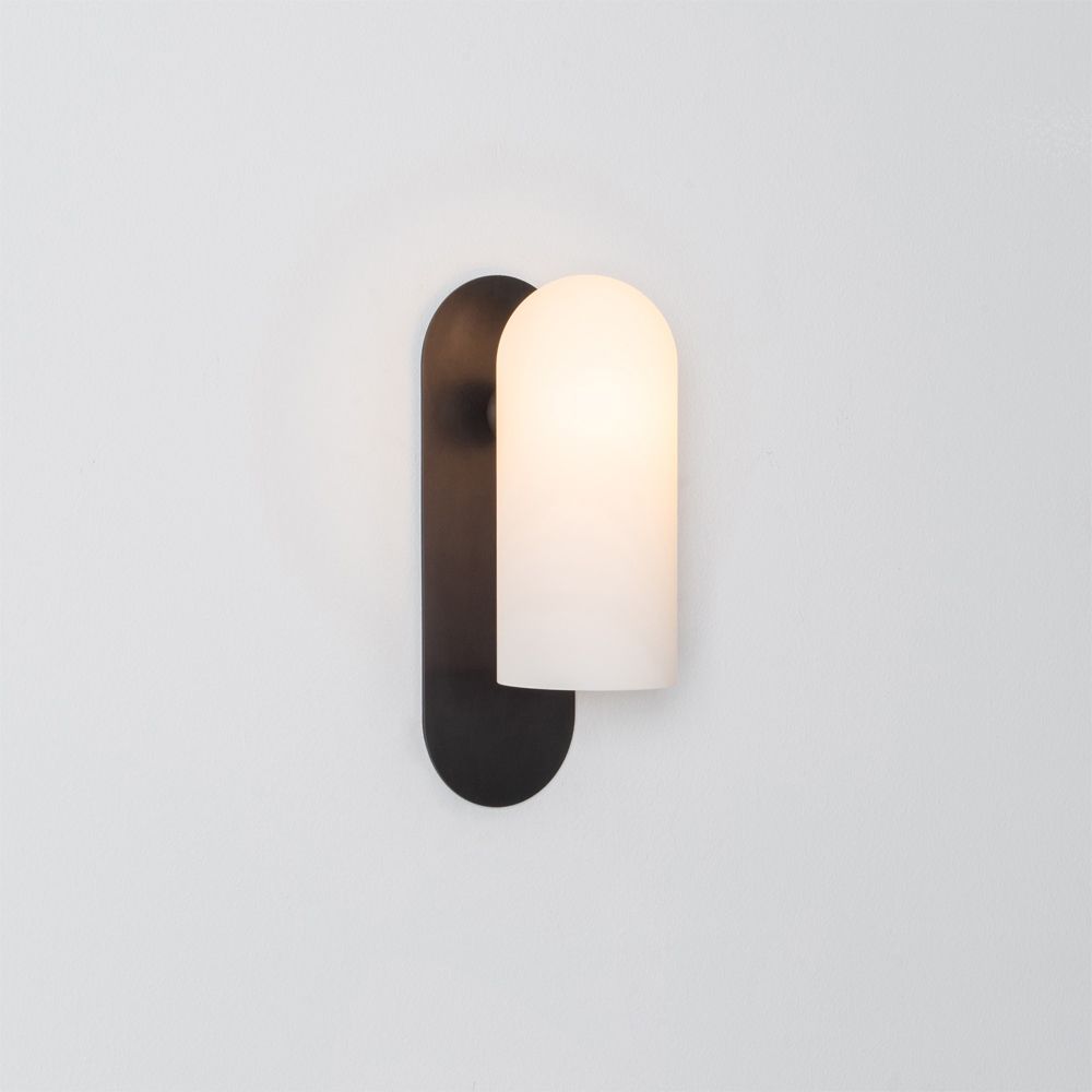 Luxurious black gunmetal brass wall lamp with a long translucent glass shade