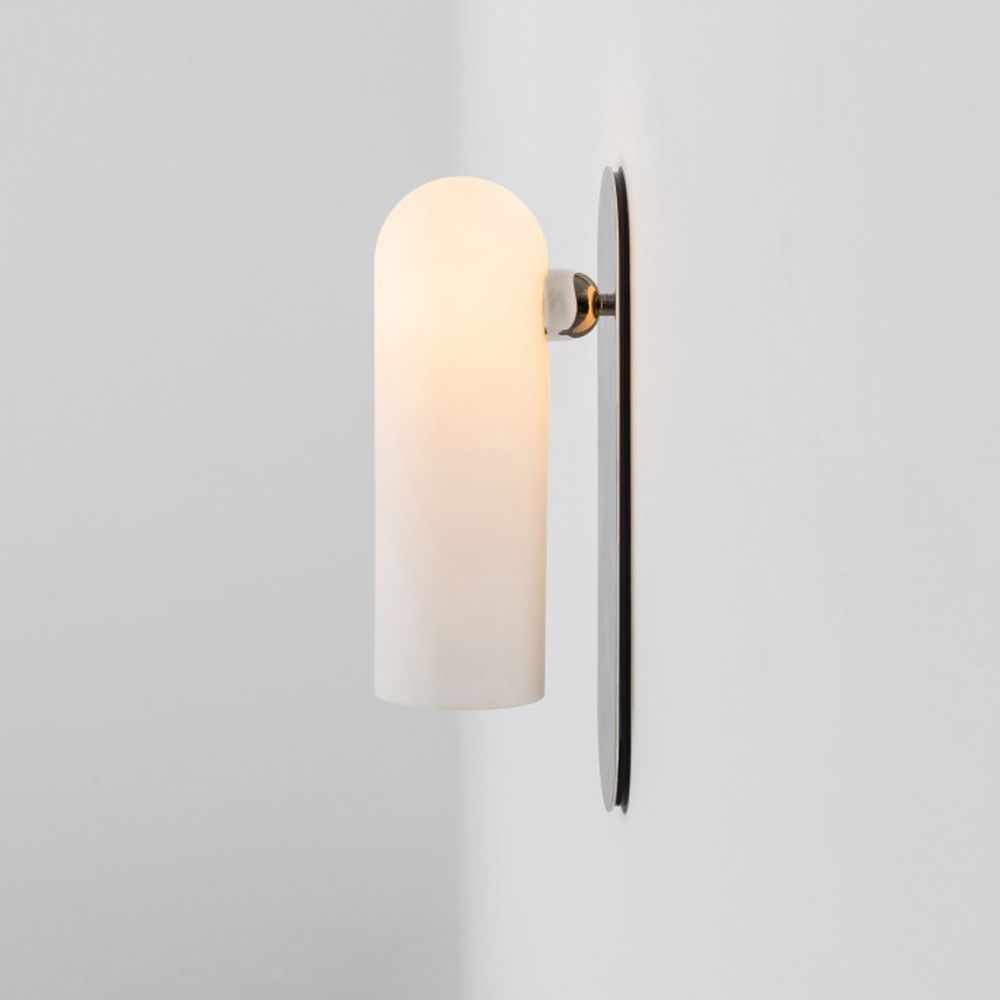 Contemporary solid brass wall lamp in a polished nickel finish with a long translucent glass lampshade