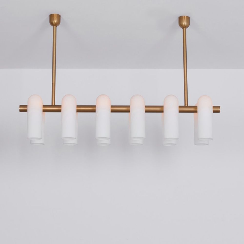 Contemporary natural brass finish chandelier with a colonnade of translucent glass lampshades 