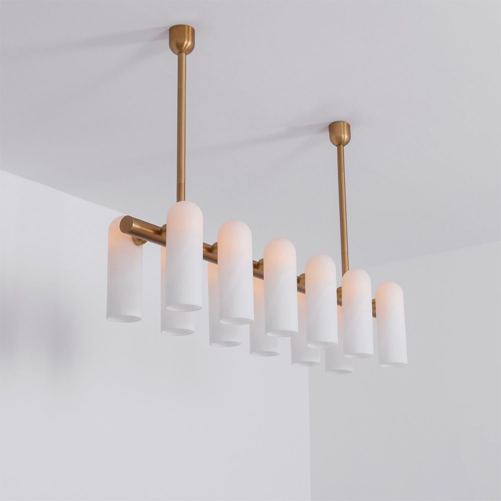 Contemporary natural brass finish chandelier with a colonnade of translucent glass lampshades 
