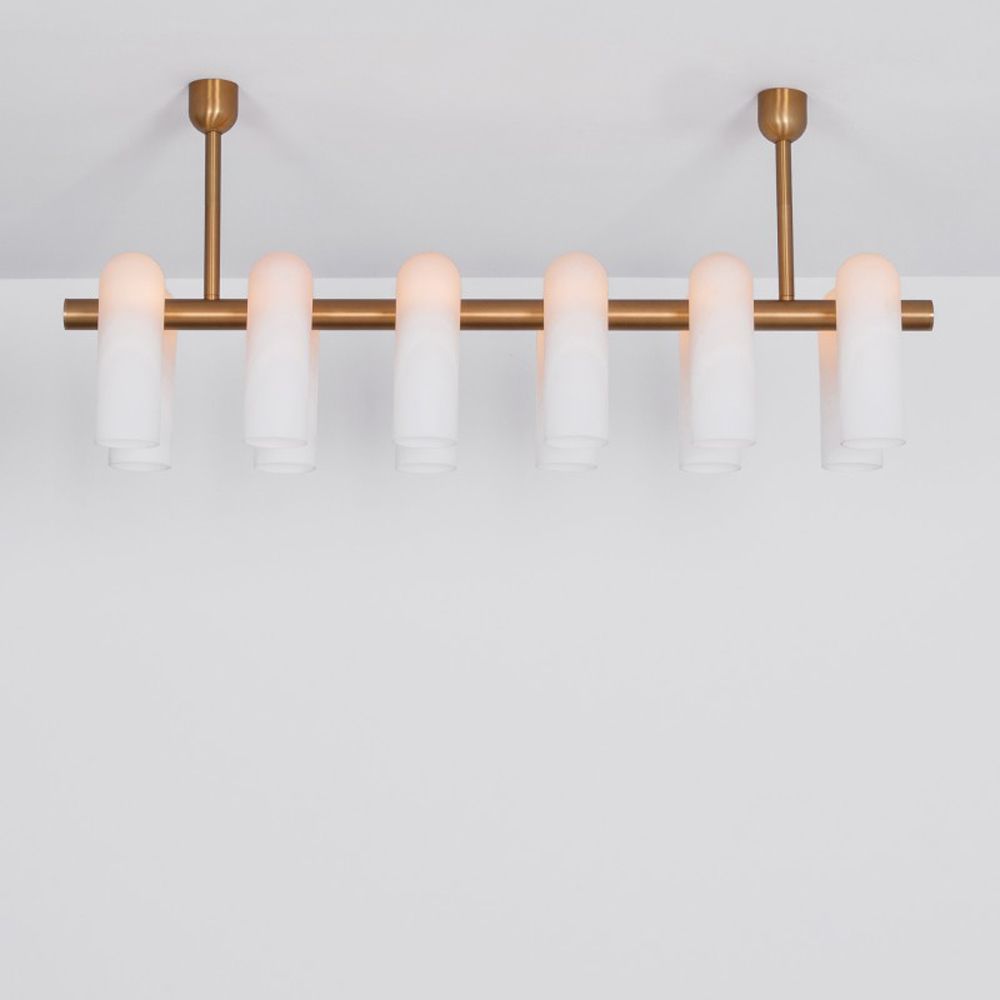 Contemporary natural brass finish chandelier with a colonnade of translucent glass lampshades 