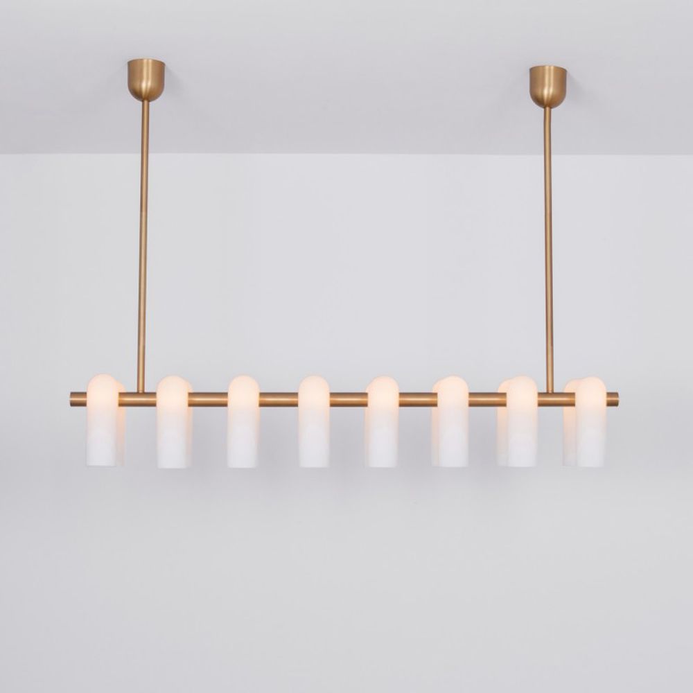 Contemporary natural brass finish chandelier with a colonnade of translucent glass lampshades